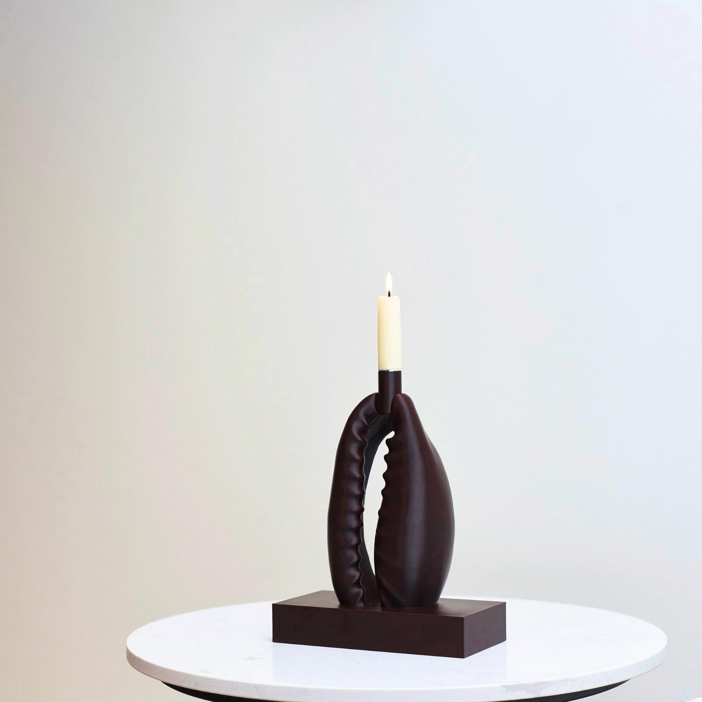 3D-printed cowrie-shaped artifacts blending ancient symbolism with modern design