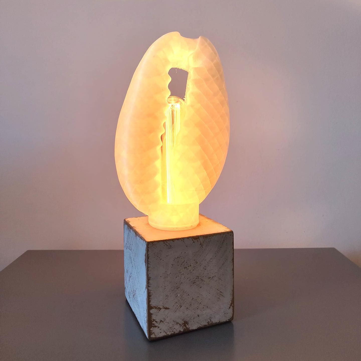 3D-printed cowrie-shaped artifacts blending ancient symbolism with modern design